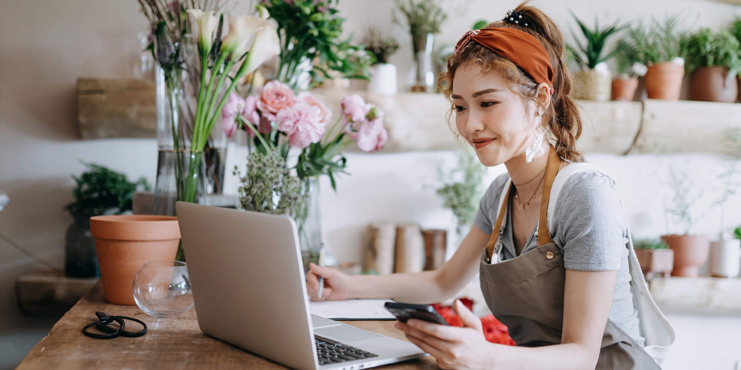 A florist working on her laptop computer.