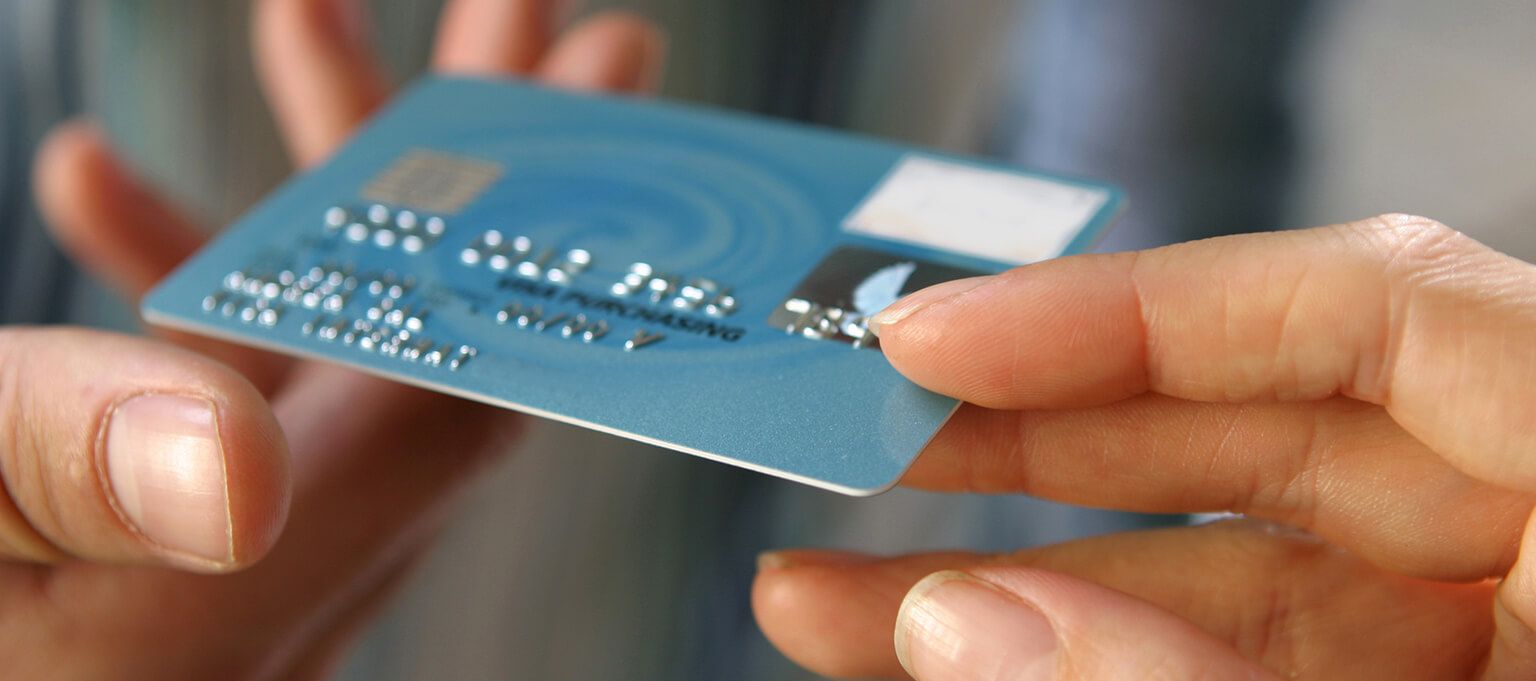 Close up image of Hand holding debit card