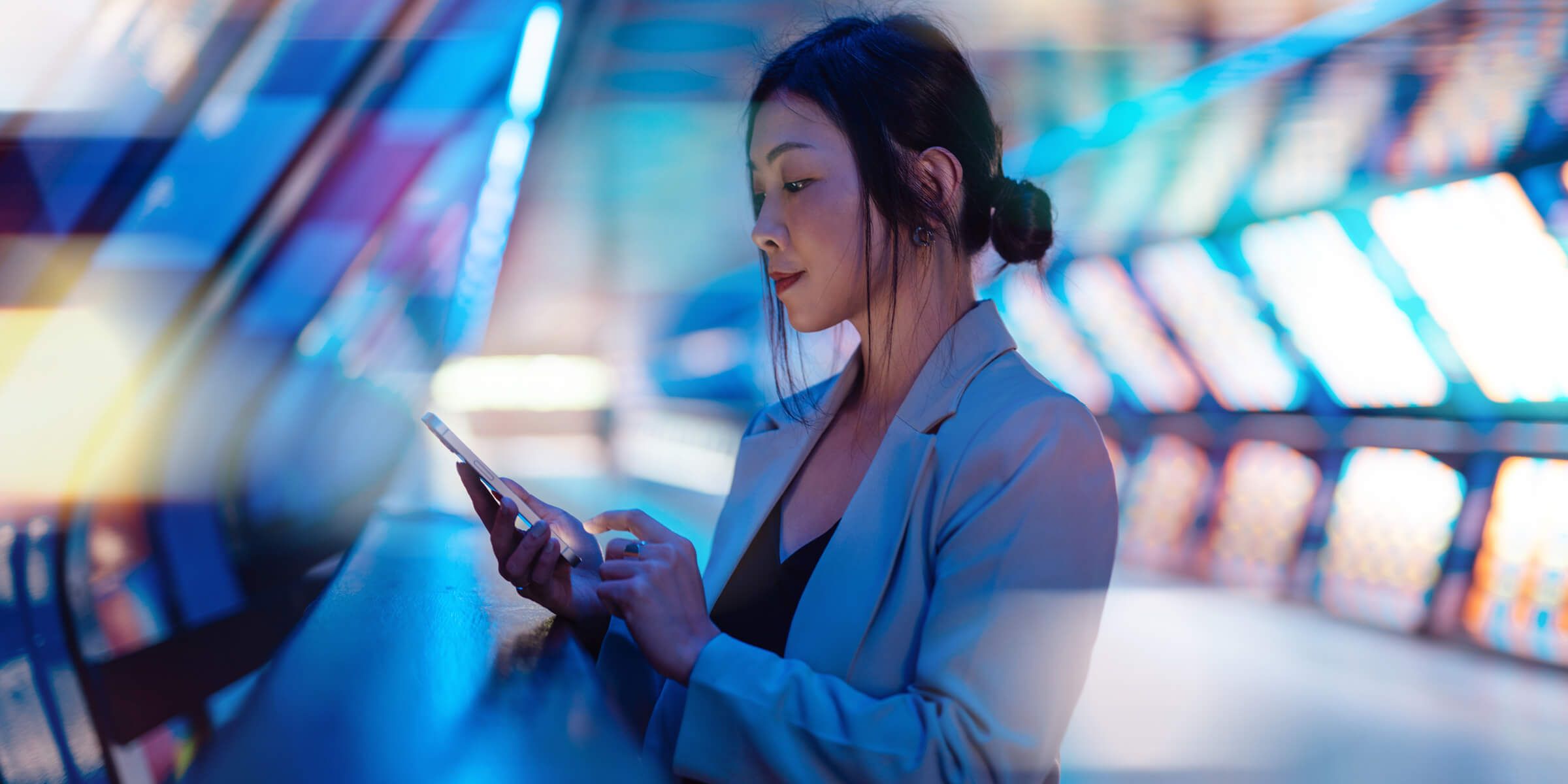 Asian woman typing on cell phone