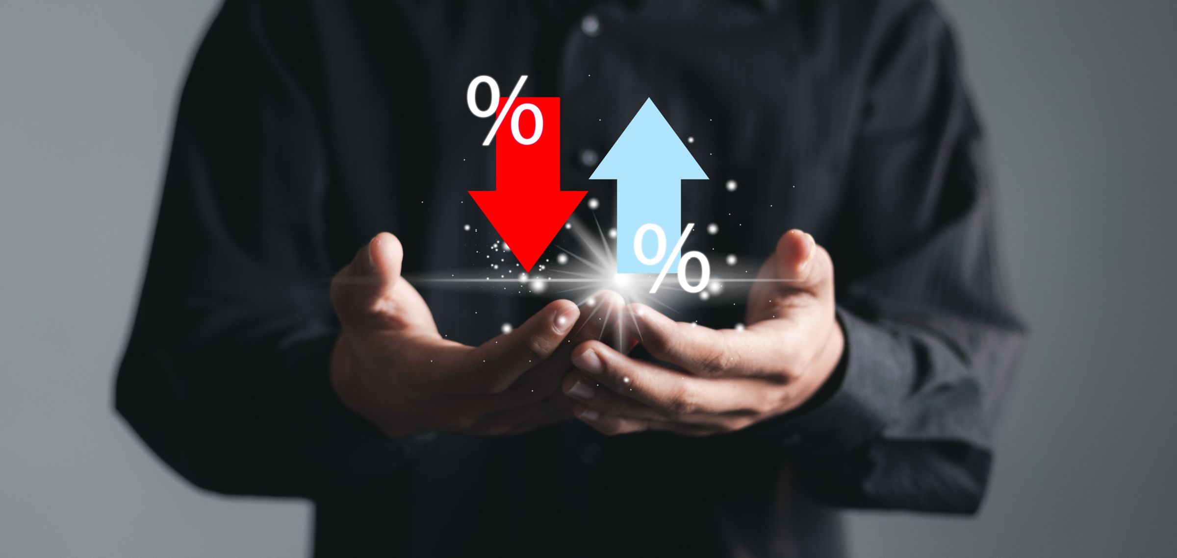 Businessman showing percentage icons with up and down arrow icons and graph indicators.