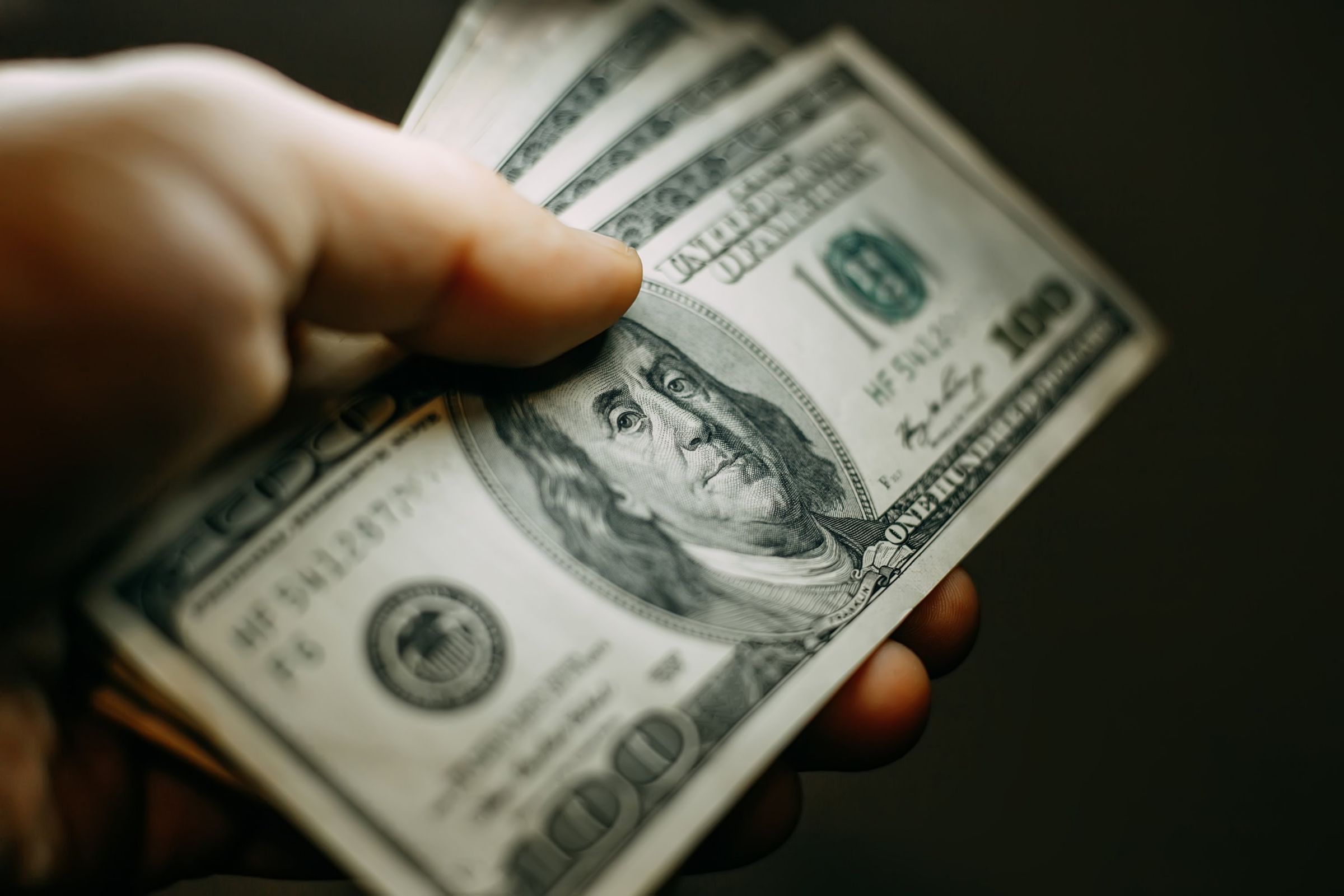 Close up image a man's hand holding cash 