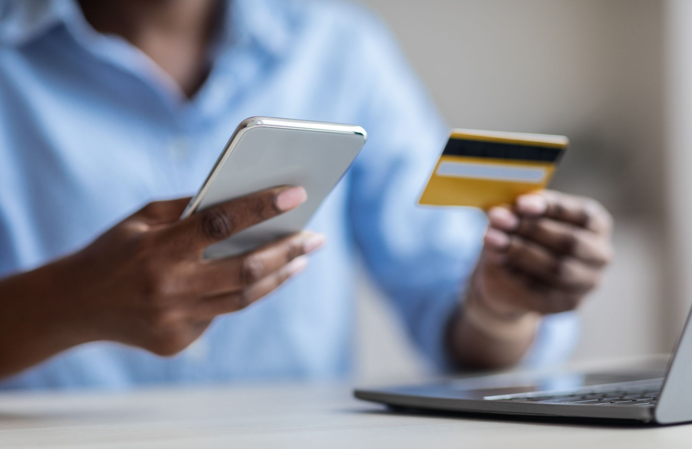 a person holding an electronic card and a phone