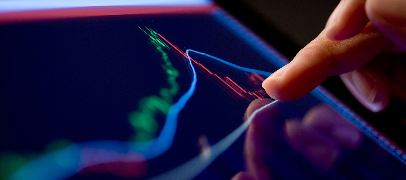 Close up image of tablet device displaying financial graph