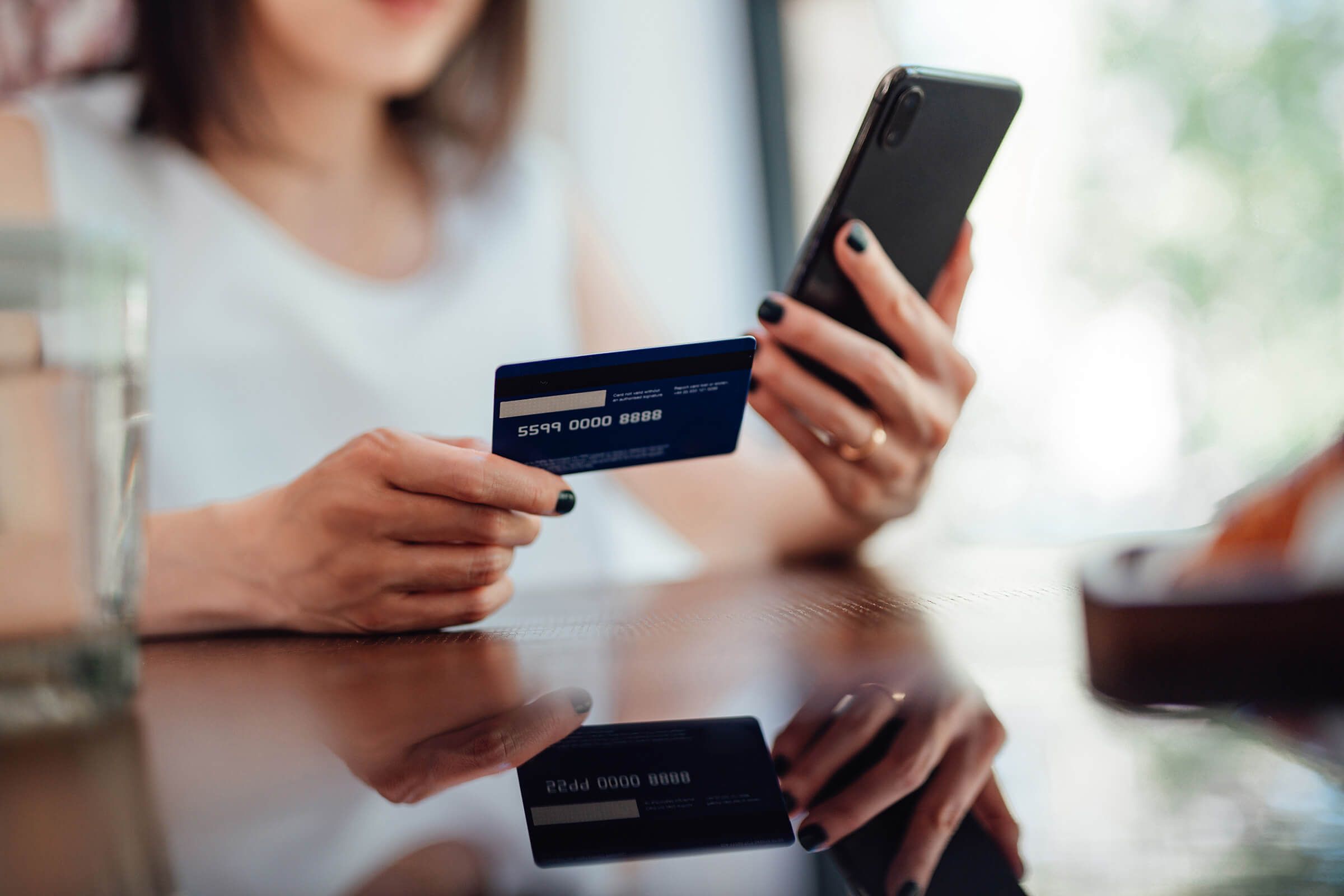 women holding credit card and phone