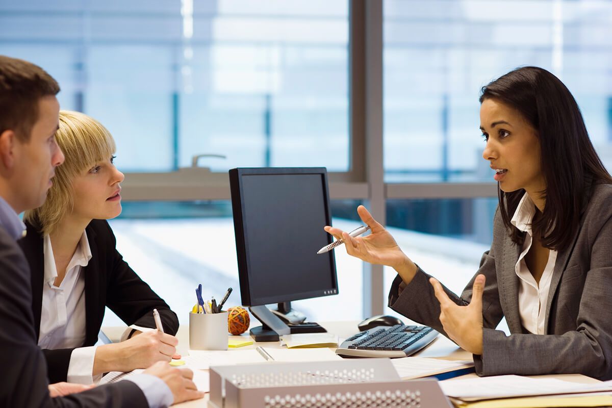 Customers speaking with banker.