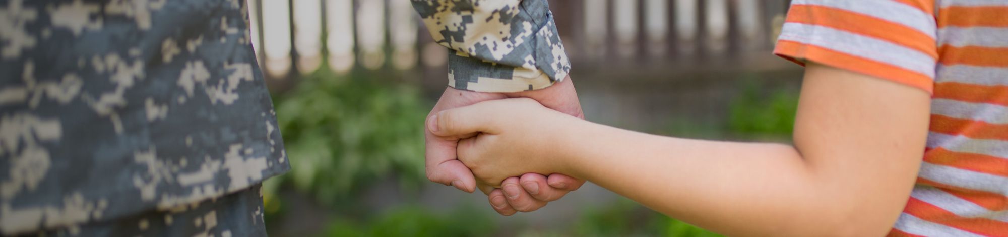 a close up of a person holding a child’s hand