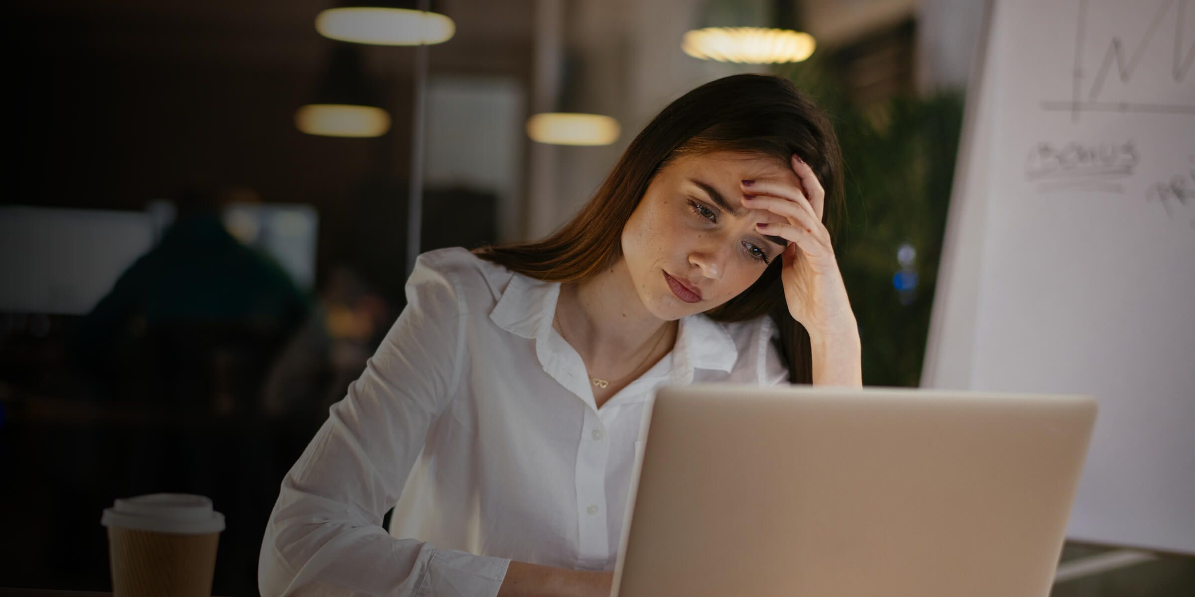 GIrl looking sad looking at laptop