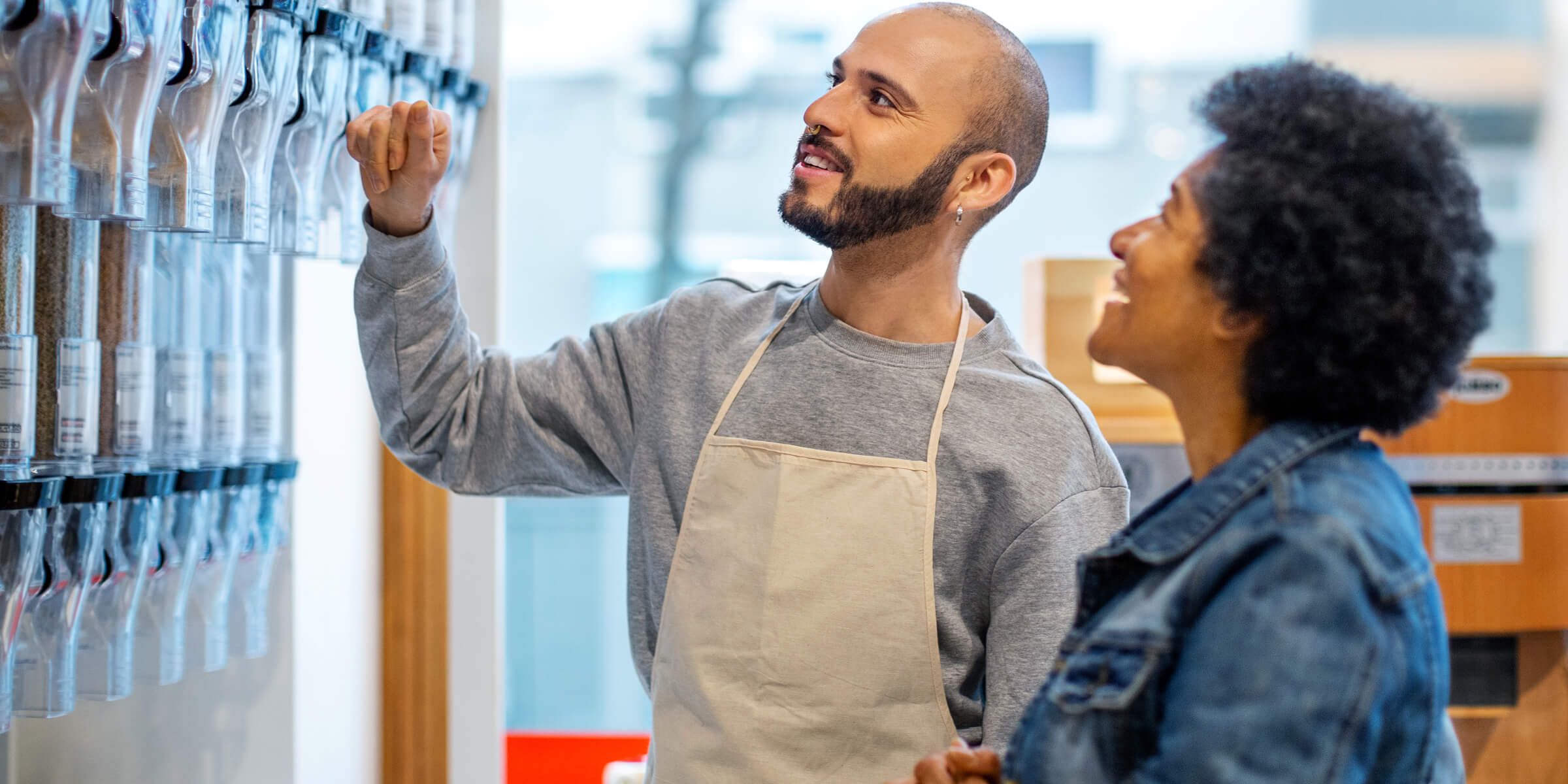 An employee helping a customer select something