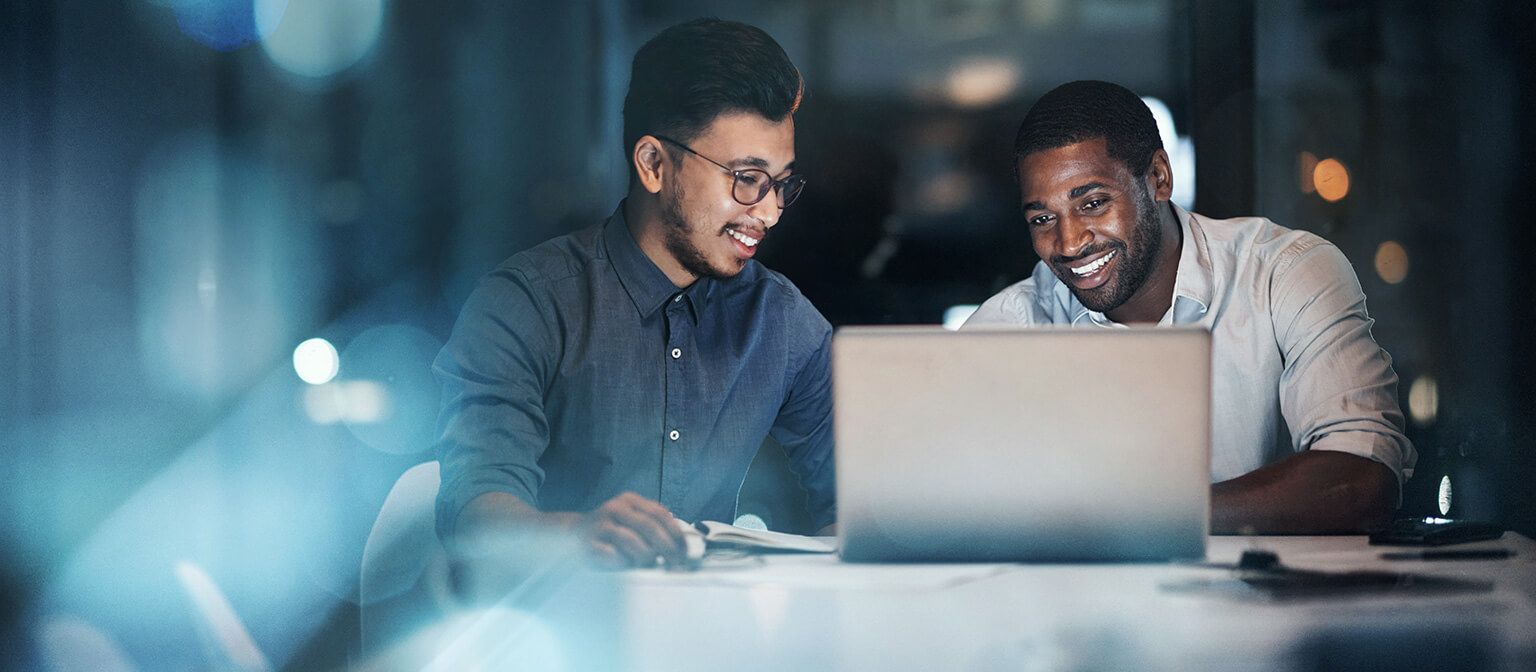 Two businessmen working at laptop