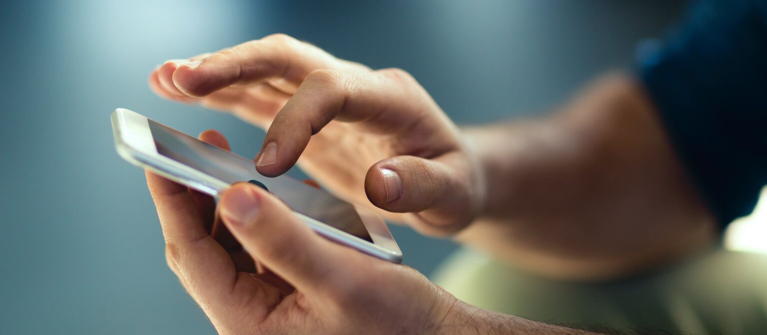 Close up image of hand holding mobile phone