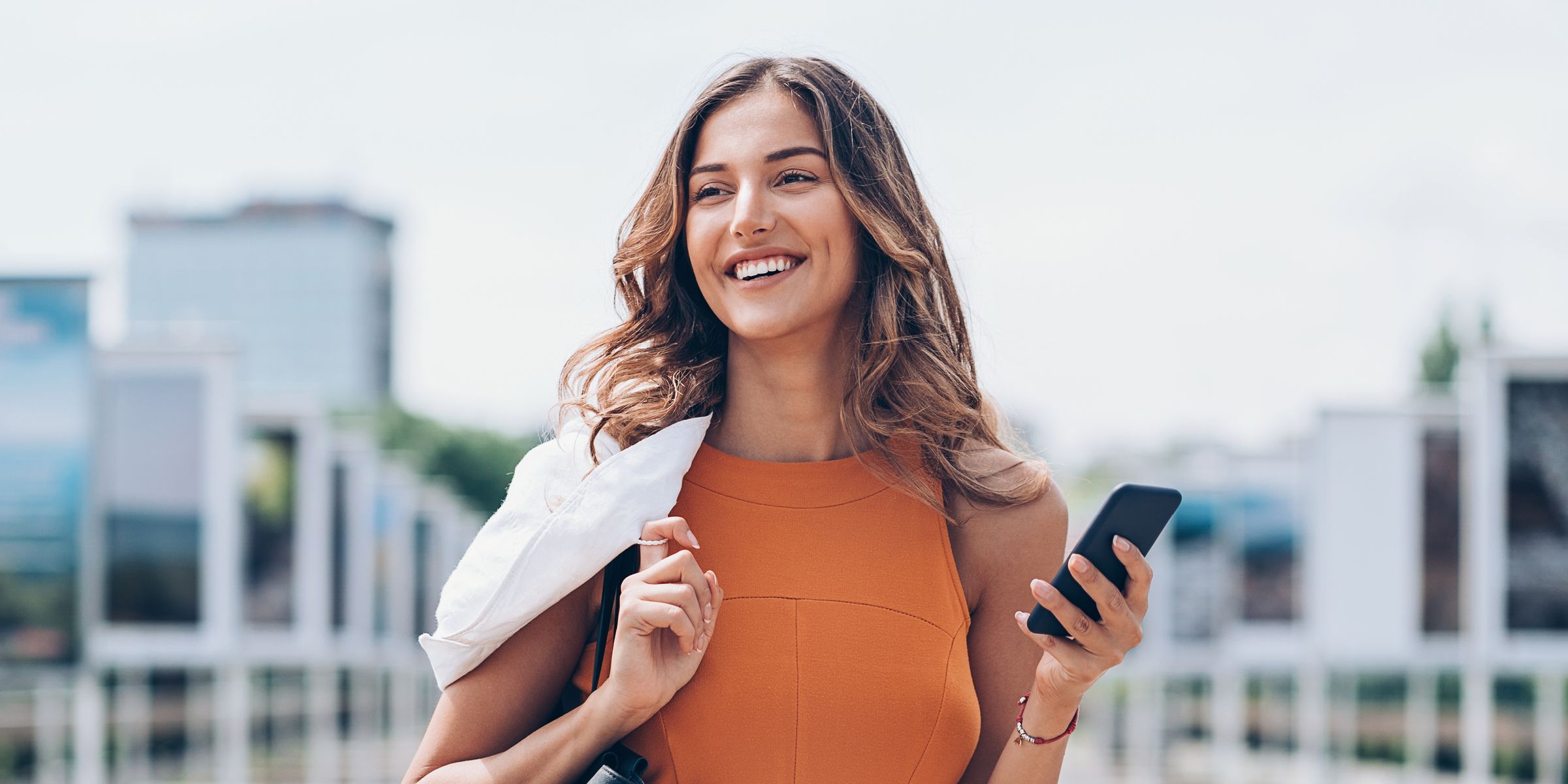 Woman smiling holding phone