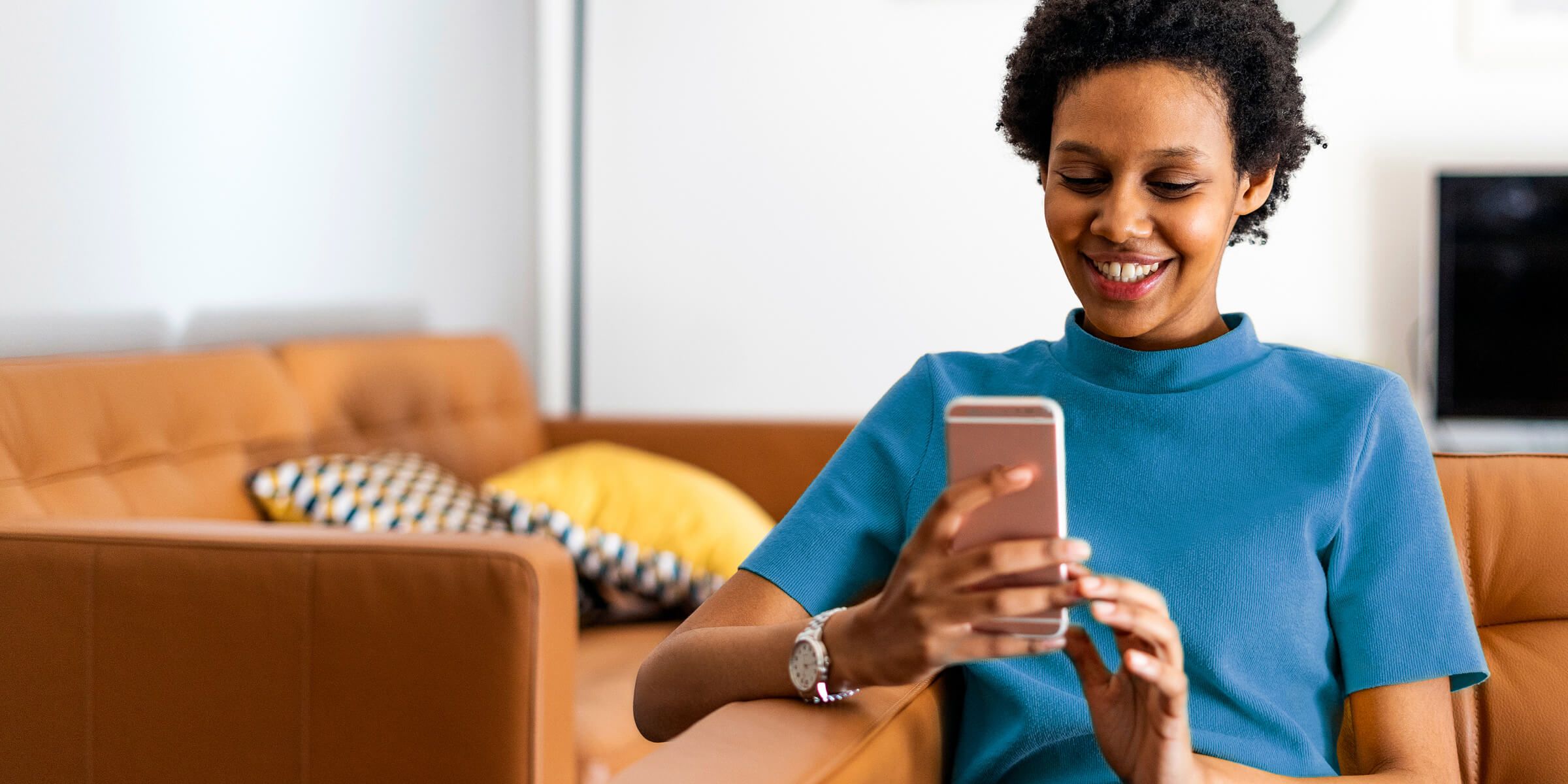 fiserv-woman-using-smartphone-1193057978-rt-2400x1200.jpg
