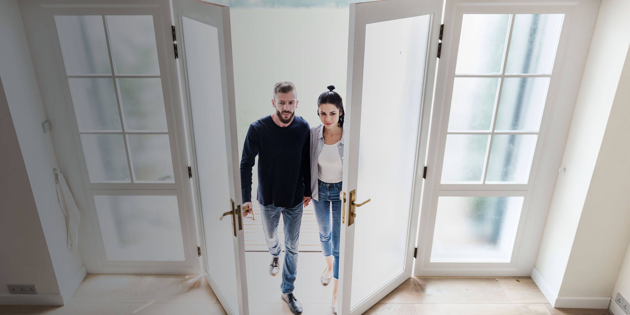 a man and woman walking through a doorway