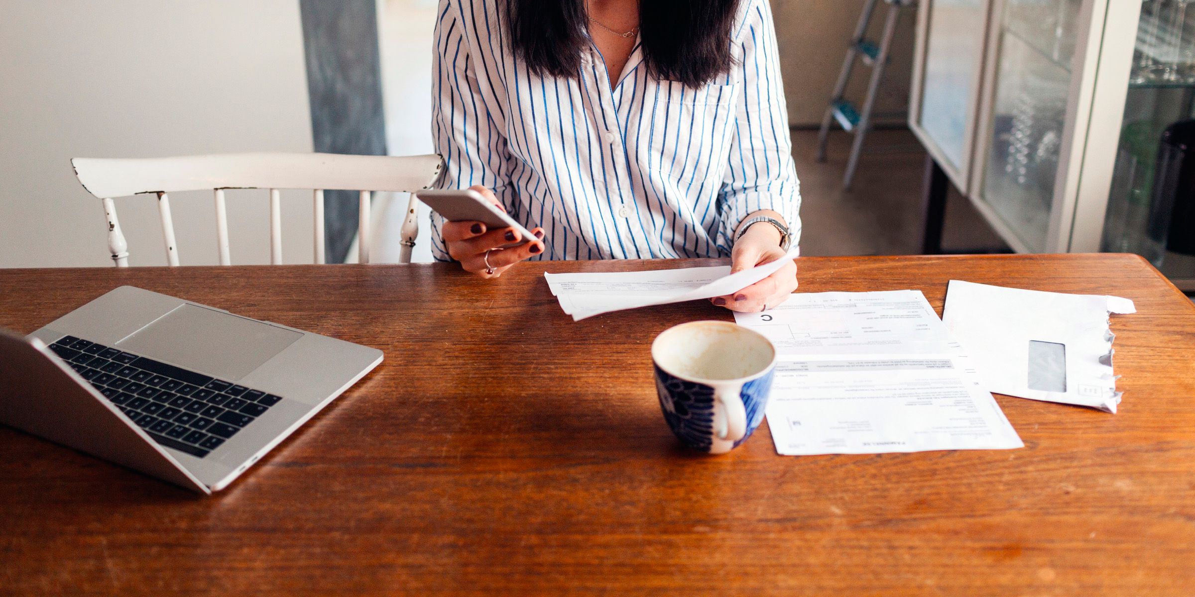 Woman holding credit card using mobile phone