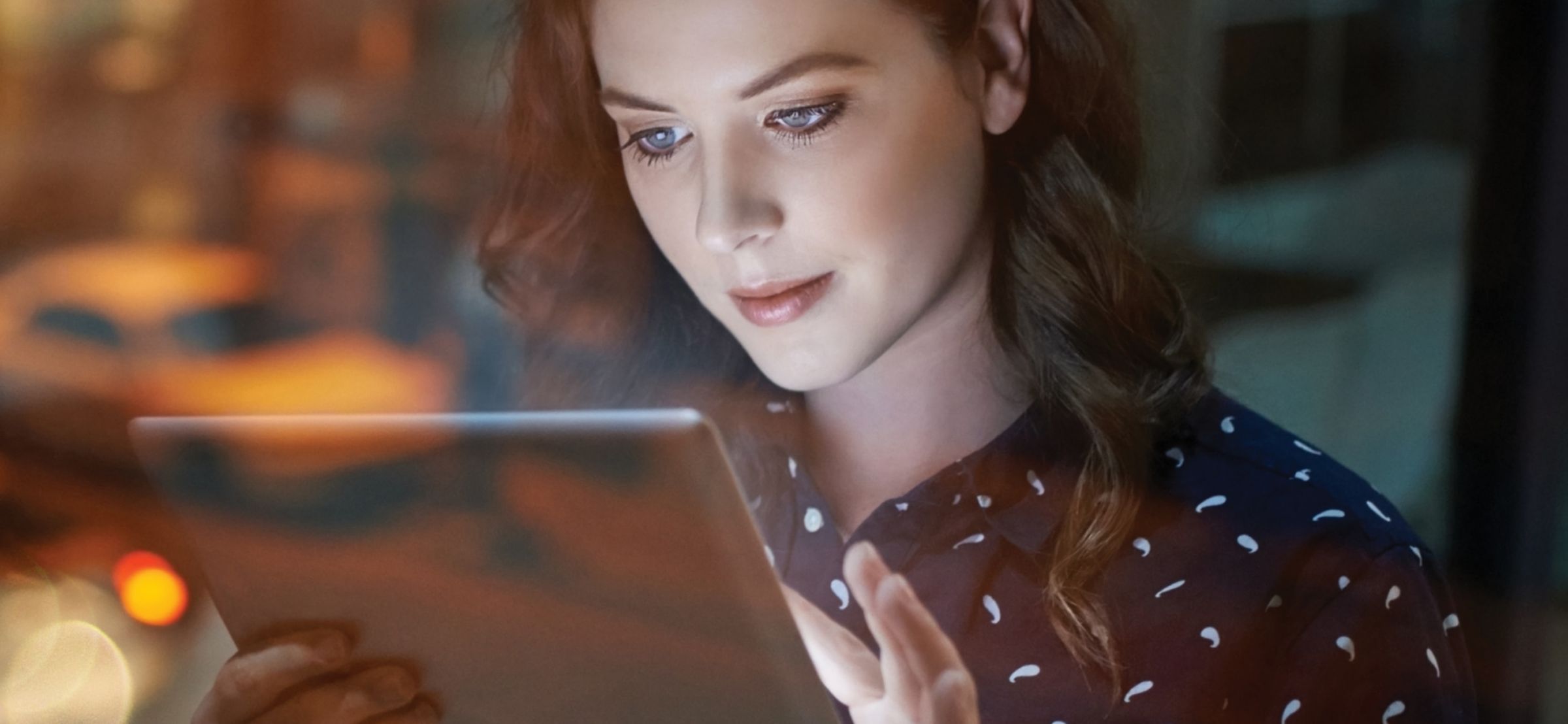 woman looking at tablet