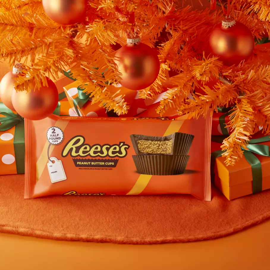 REESE'S Peanut Butter Cups underneath a christmas tree surrounded by gifts