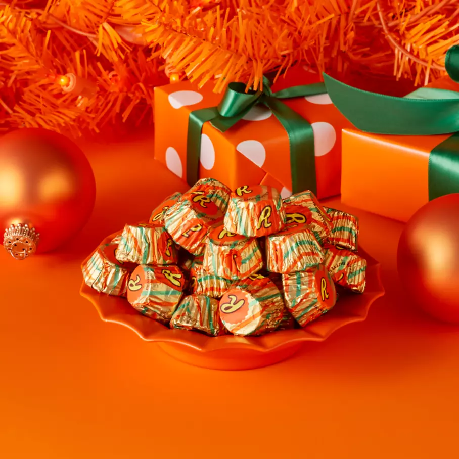 REESE'S Miniatures Peanut Butter Cups underneath tree surrounded by gifts