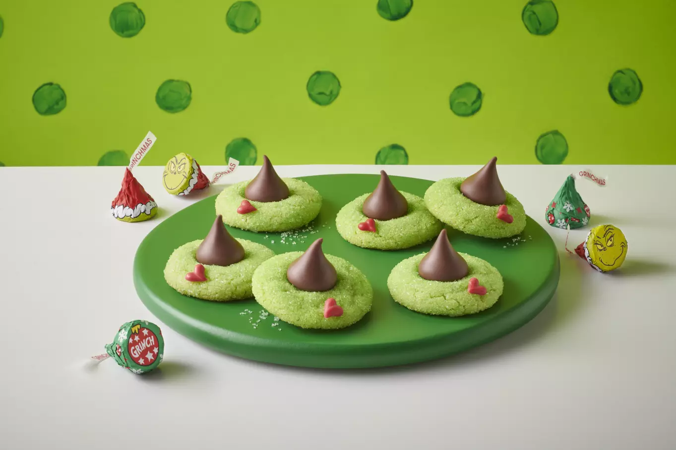 HERSHEY'S KISSES Grinch® blossom cookies on decorative plate