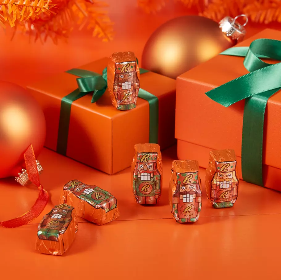 REESE'S Nutcrackers under christmas tree surrounded by gifts and ornaments