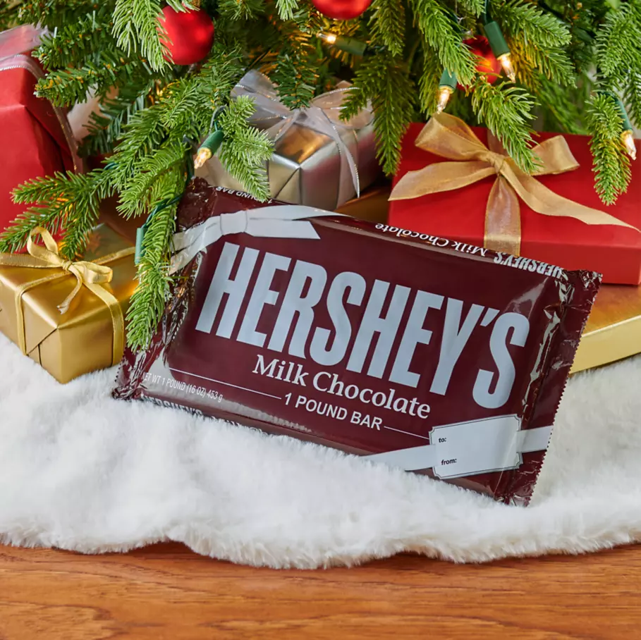 HERSHEY'S Candy Bar under christmas tree surrounded by gifts