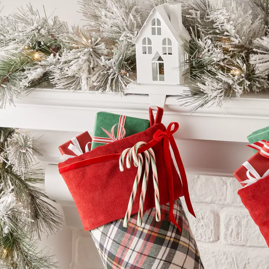 HERSHEY'S Candy Canes hanging on mantel beside stockings
