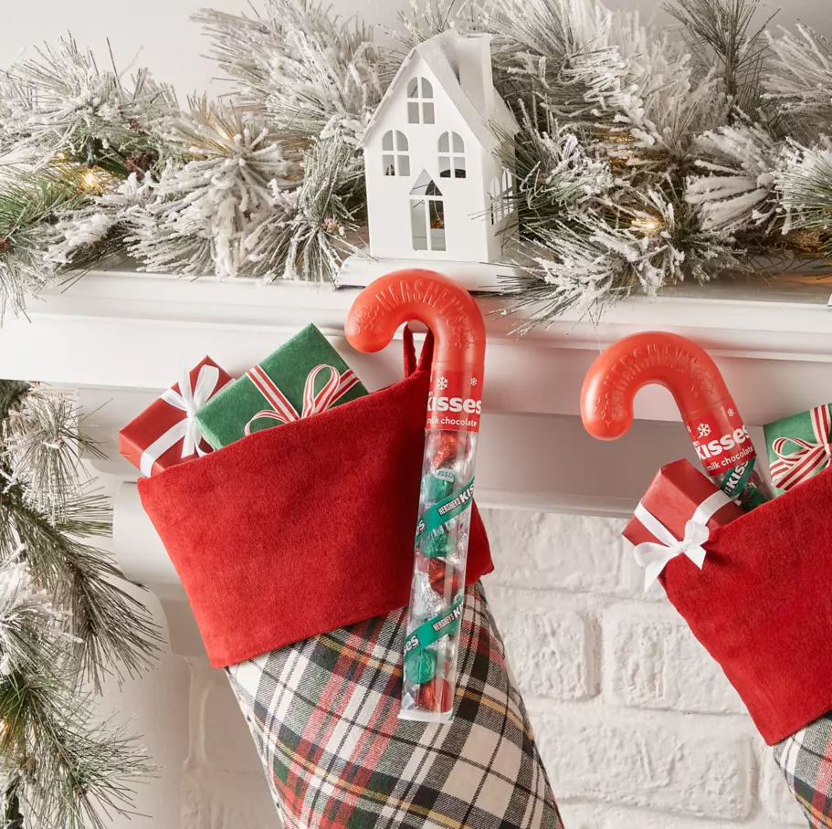 HERSHEY'S KISSES Candy Canes hanging on mantel beside stockings