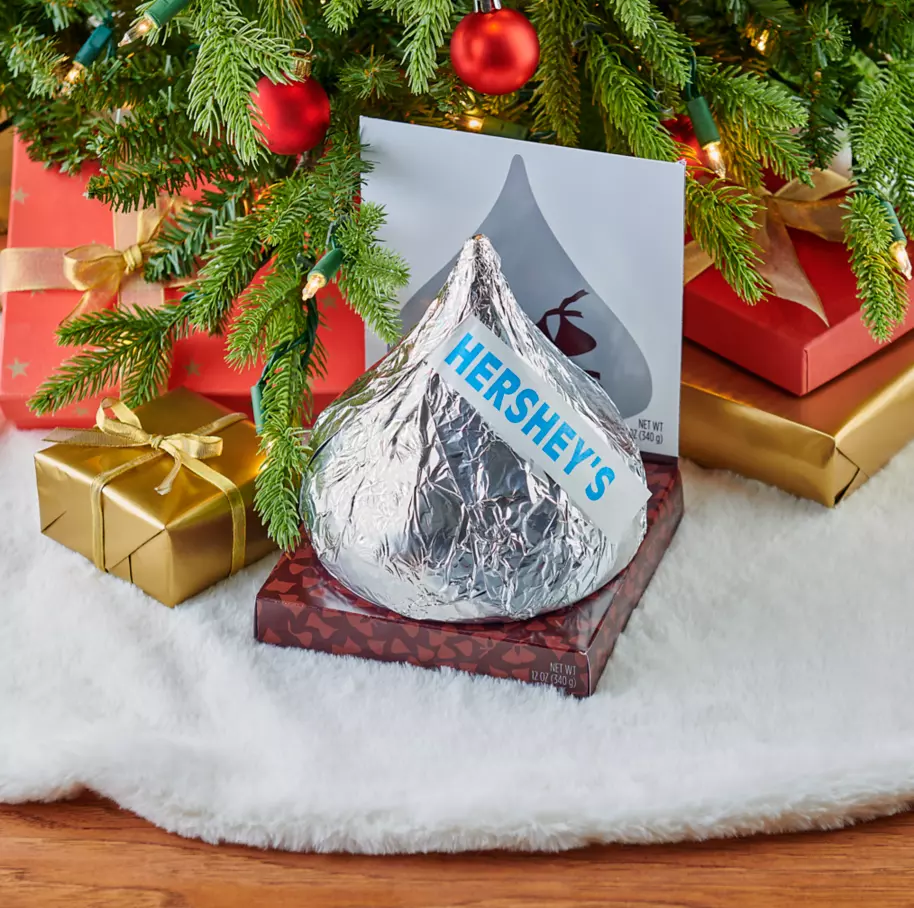 HERSHEY'S KISSES Giant Candy under christmas tree surrounded by gifts