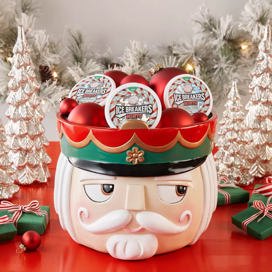ICE BREAKERS Pucks inside nutcracker bowl surrounded by ornaments