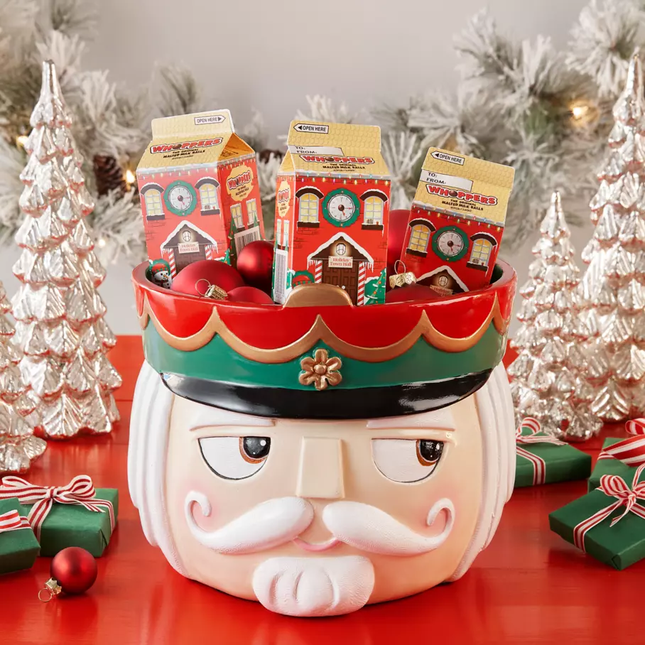 WHOPPERS Malted Milk Ball Cartons inside nutcracker bowl surrounded by ornaments