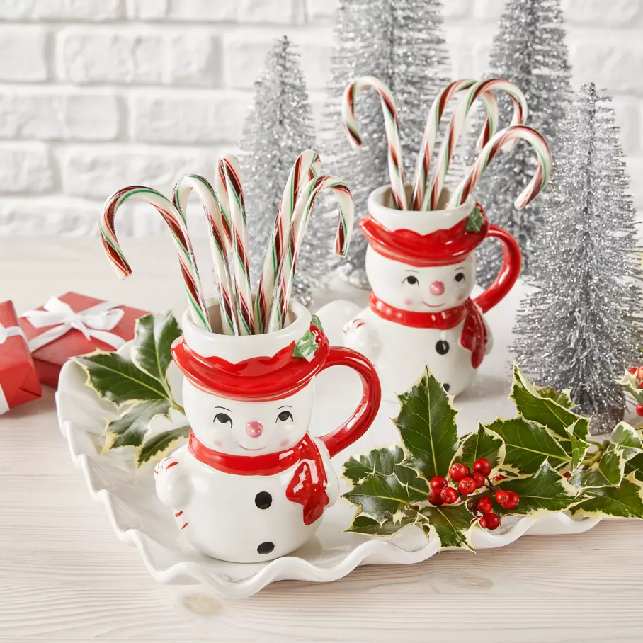 HERSHEY'S Candy Canes inside two snowman mugs