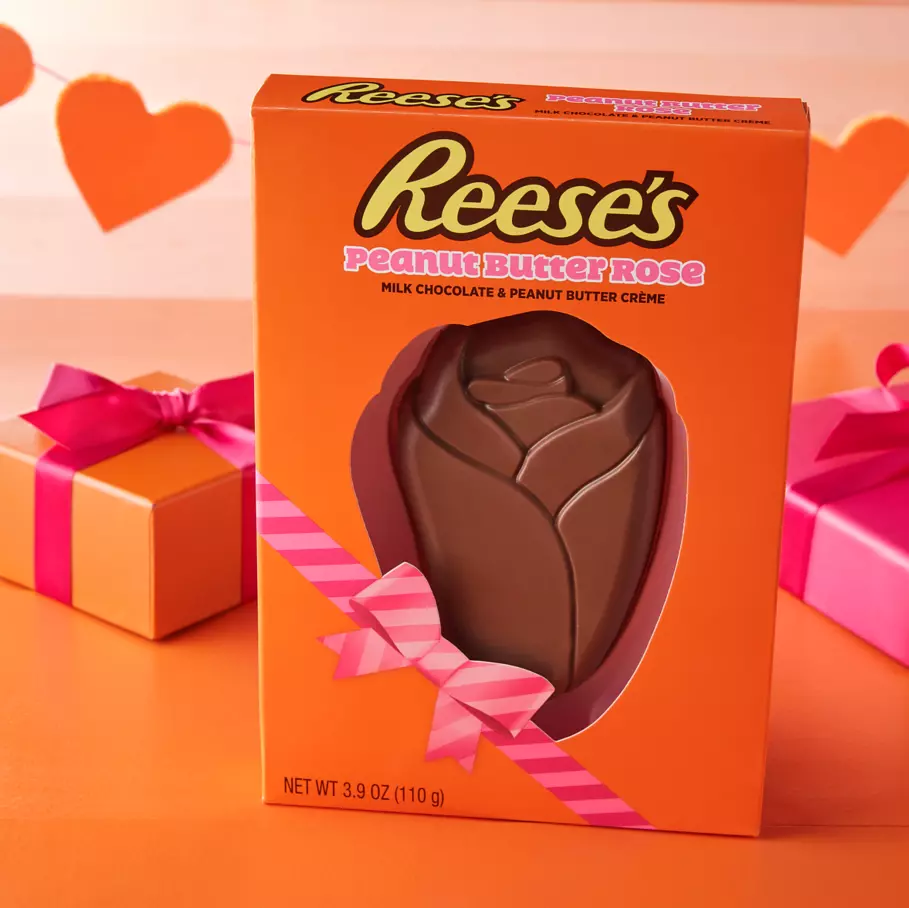 REESE'S peanut butter rose package on table surrounded by gifts