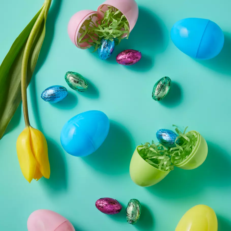 HERSHEY'S Eggs surrounded by flowers and Easter eggs