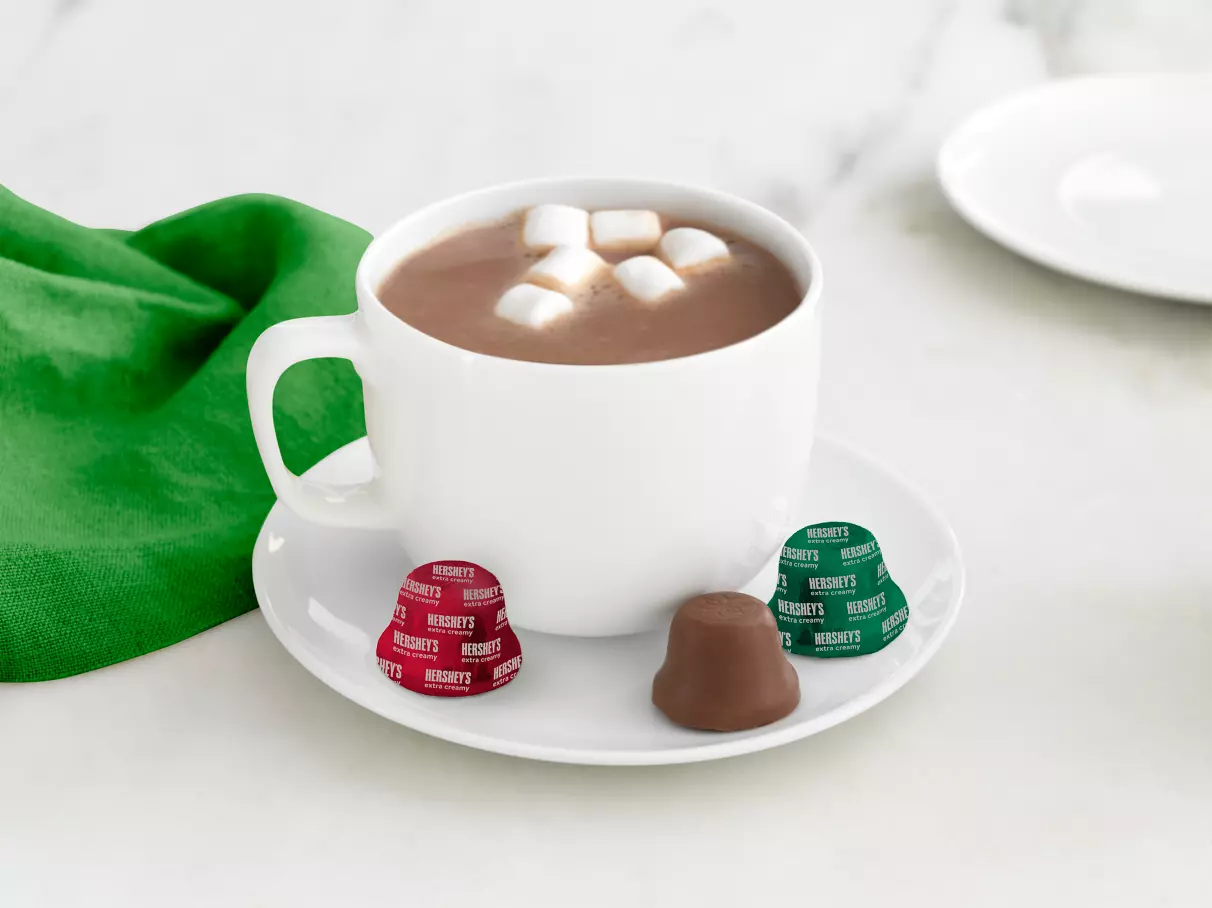 Mug of hot cocoa surrounded by HERSHEY'S Bells