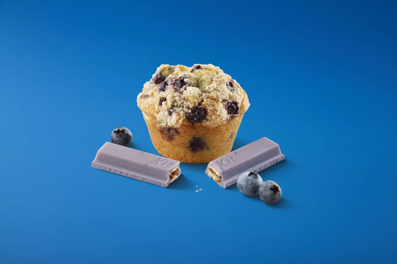 Blueberry muffin beside unwrapped candy
