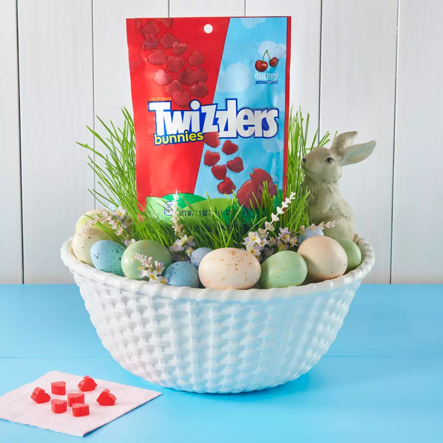 Bag of TWIZZLERS Easter Bunnies Cherry Candy inside Easter basket bowl