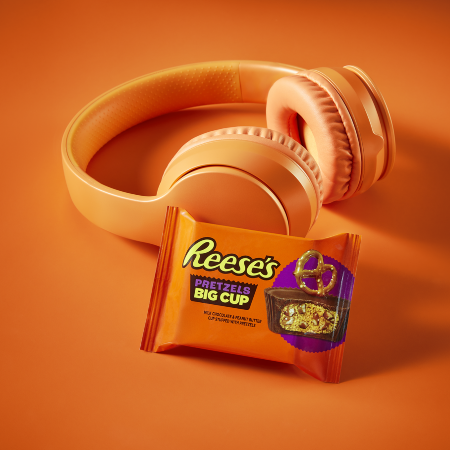 REESE'S Big Cup with Pretzels beside pair of headphones