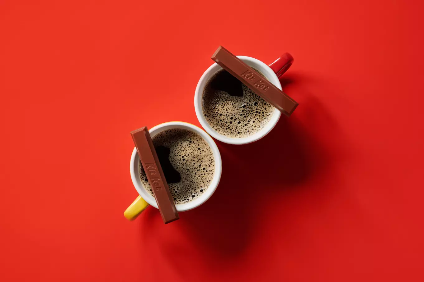KIT KAT® Milk Chocolate Candy Bars beside mugs of coffee