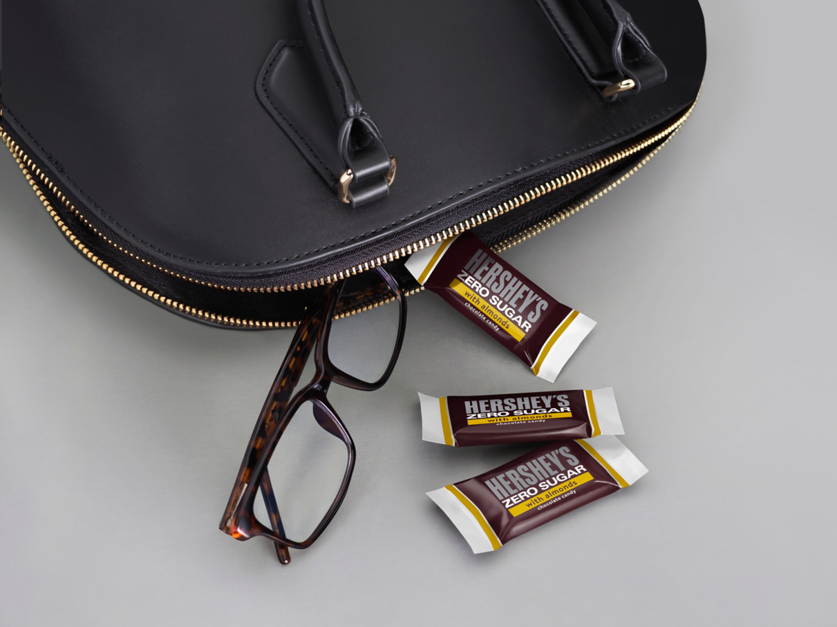HERSHEY'S zero sugar candy bars beside purse