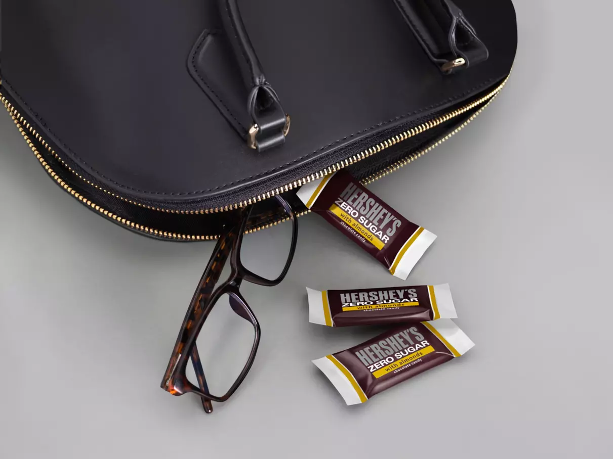 HERSHEY'S Zero Sugar with Almonds Candy Bars beside purse