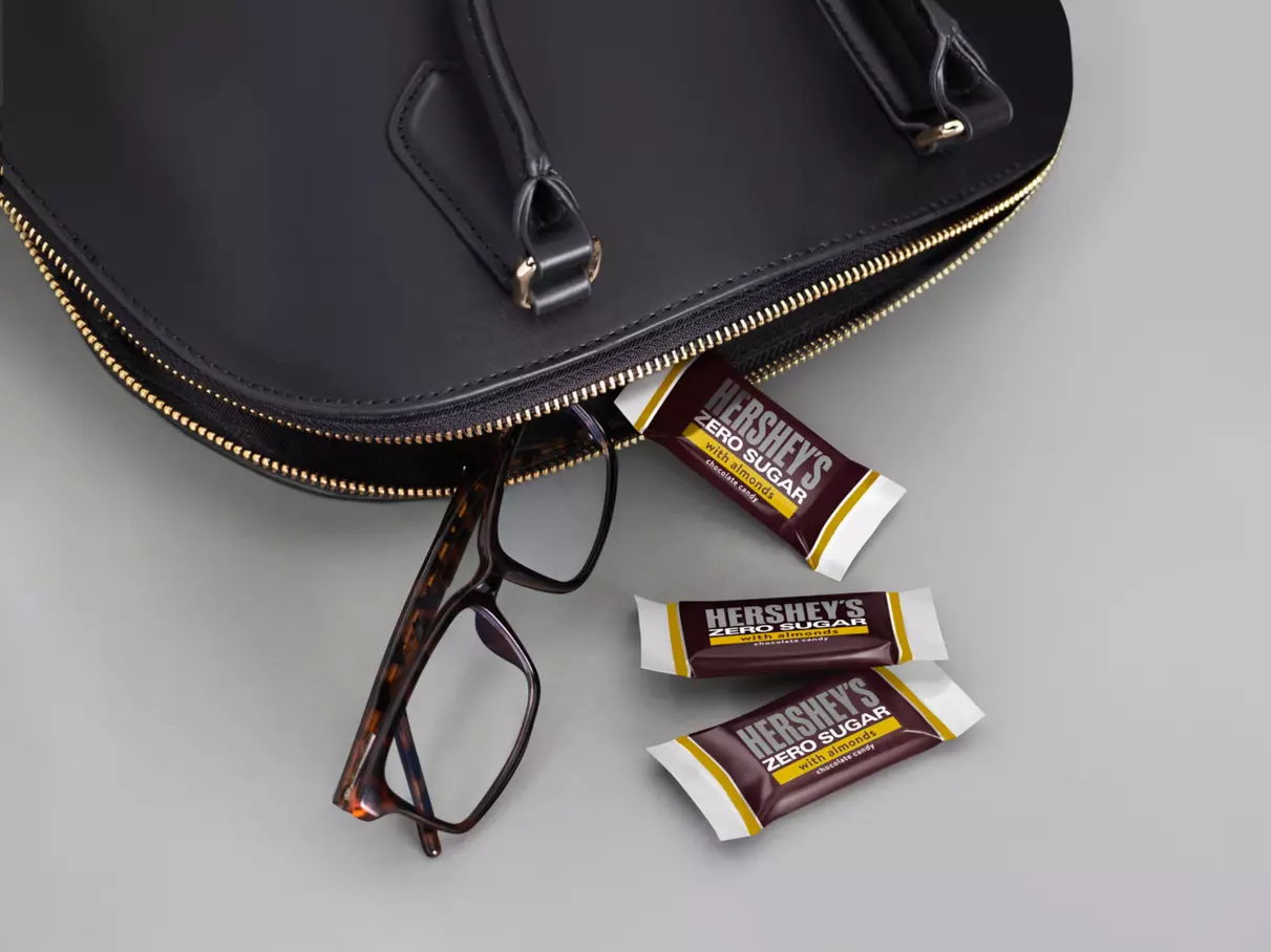 HERSHEY'S Zero Sugar with Almonds Candy beside purse