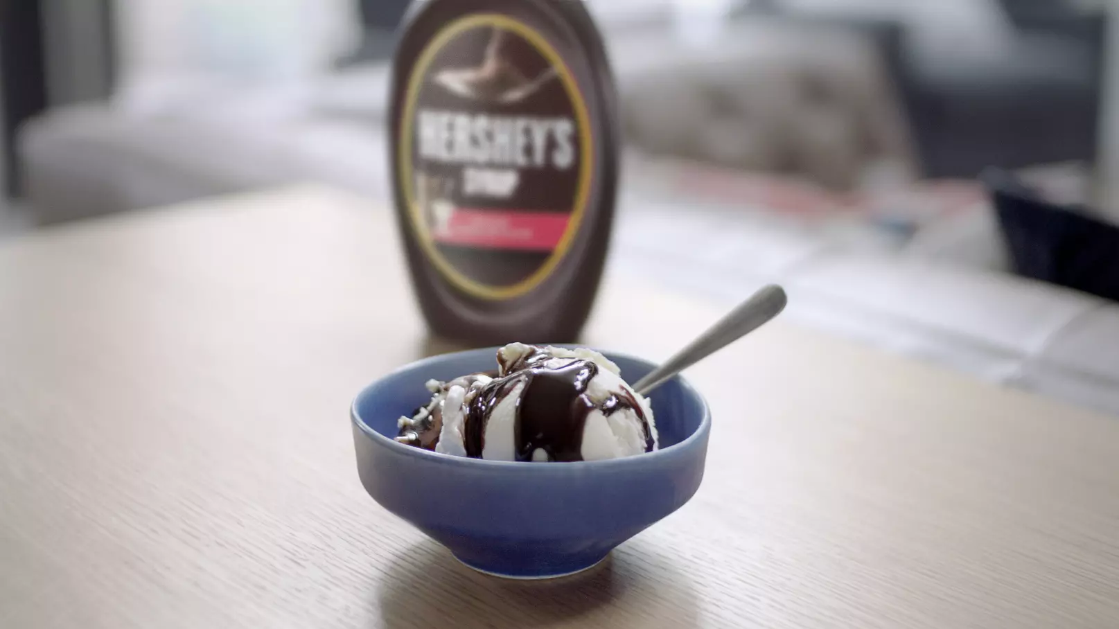Vanilla ice cream with HERSHEY'S SPECIAL DARK Mildly Sweet Chocolate Syrup on top