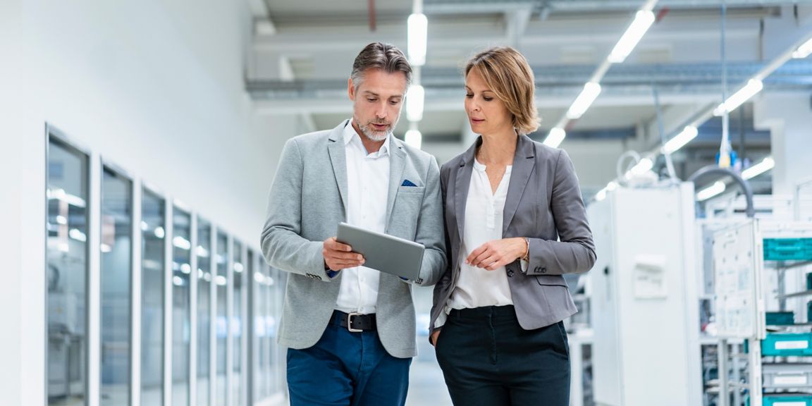 Consultants looking at iPad in building.