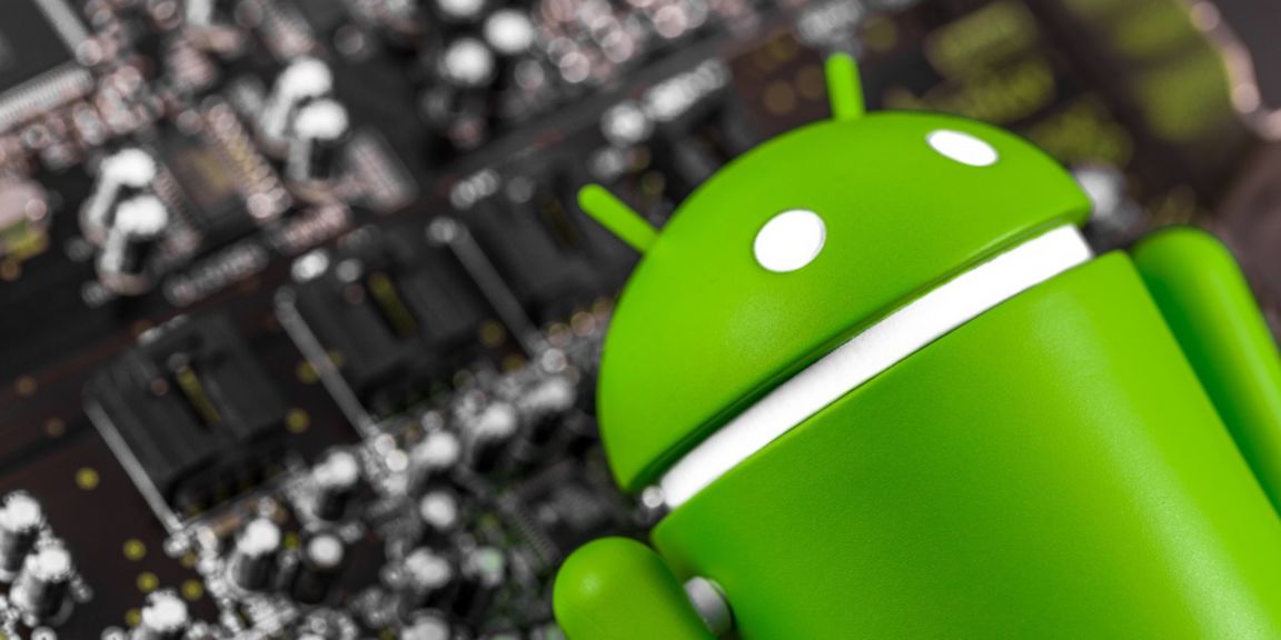 closeup Google Android figure and circuit board. Google Android is the operating system for smartphones, tablet computers, and other devices. Moscow, Russia - March 17, 2019