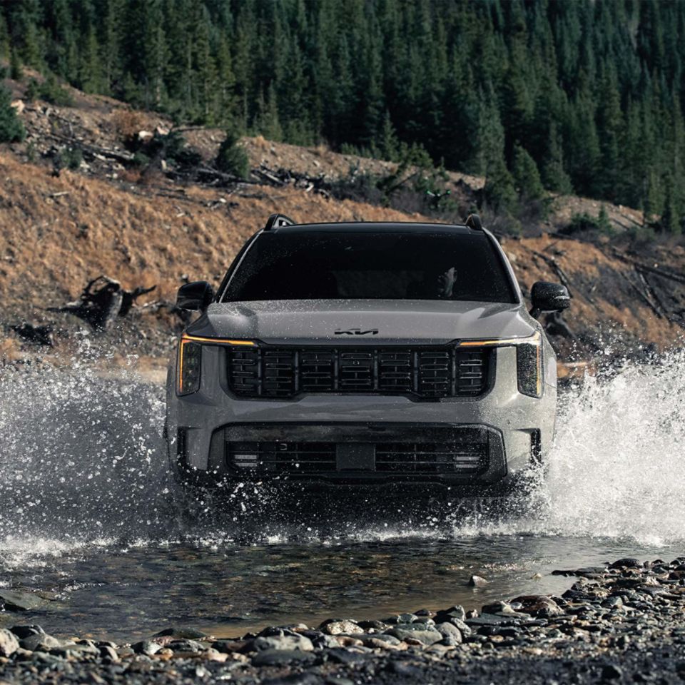2026 Kia Sorento Using Its Turbocharged Power to Drive Through a Small River Three-Quarter View