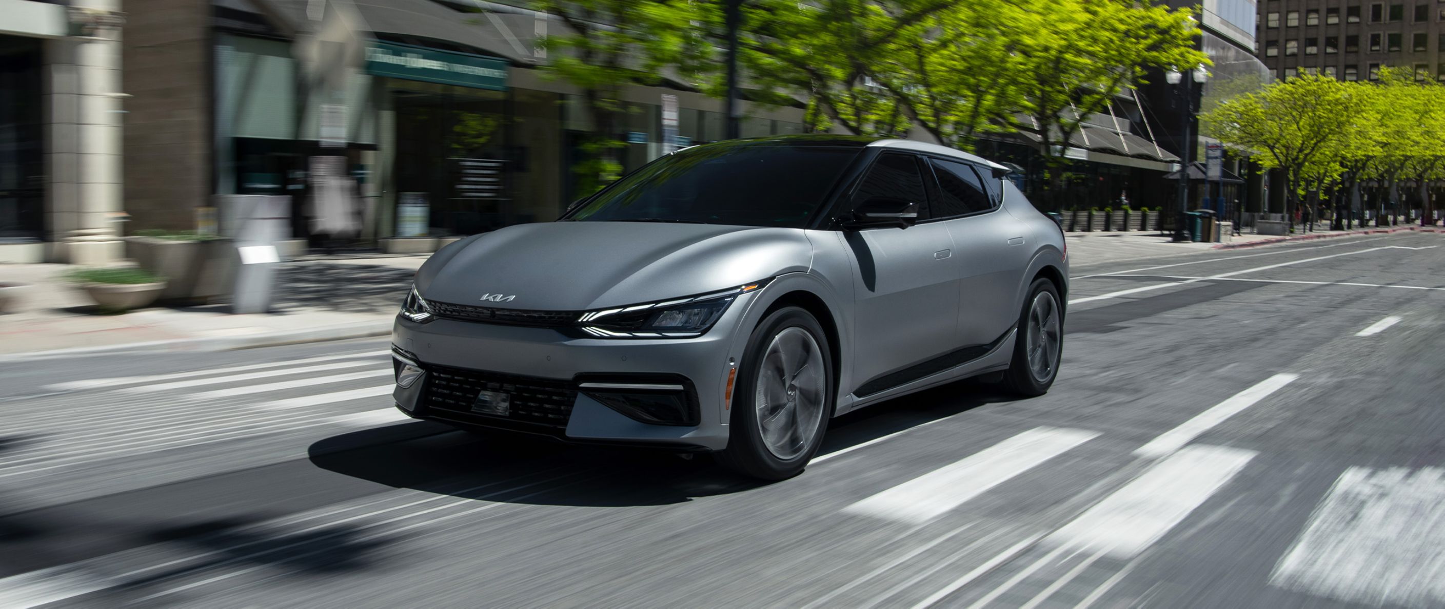 2024 Kia EV6 Accelerating Fast Down An Empty Road In The City Three-Quarter View