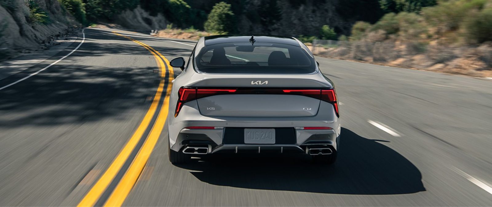 A rear view of the 2025 Kia K5 showing off the Kia badge and taillights