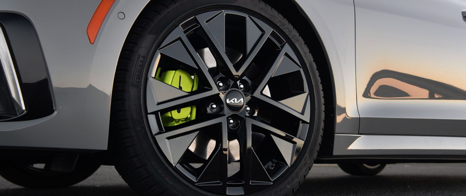 A ground-level view of the 2025 Kia K5 featuring detail on the available performance-enhancing Pirelli P-Zero tires