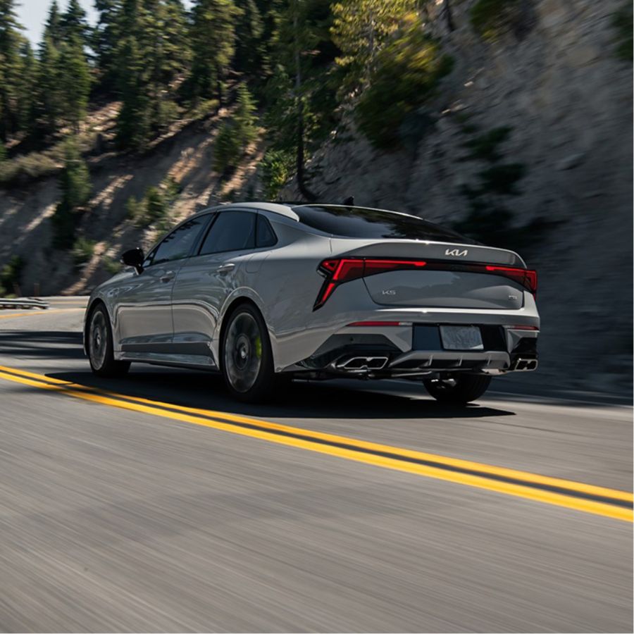 Rear angle of the 2025 Kia K5 GT in light grey featuring stylish design and taillights