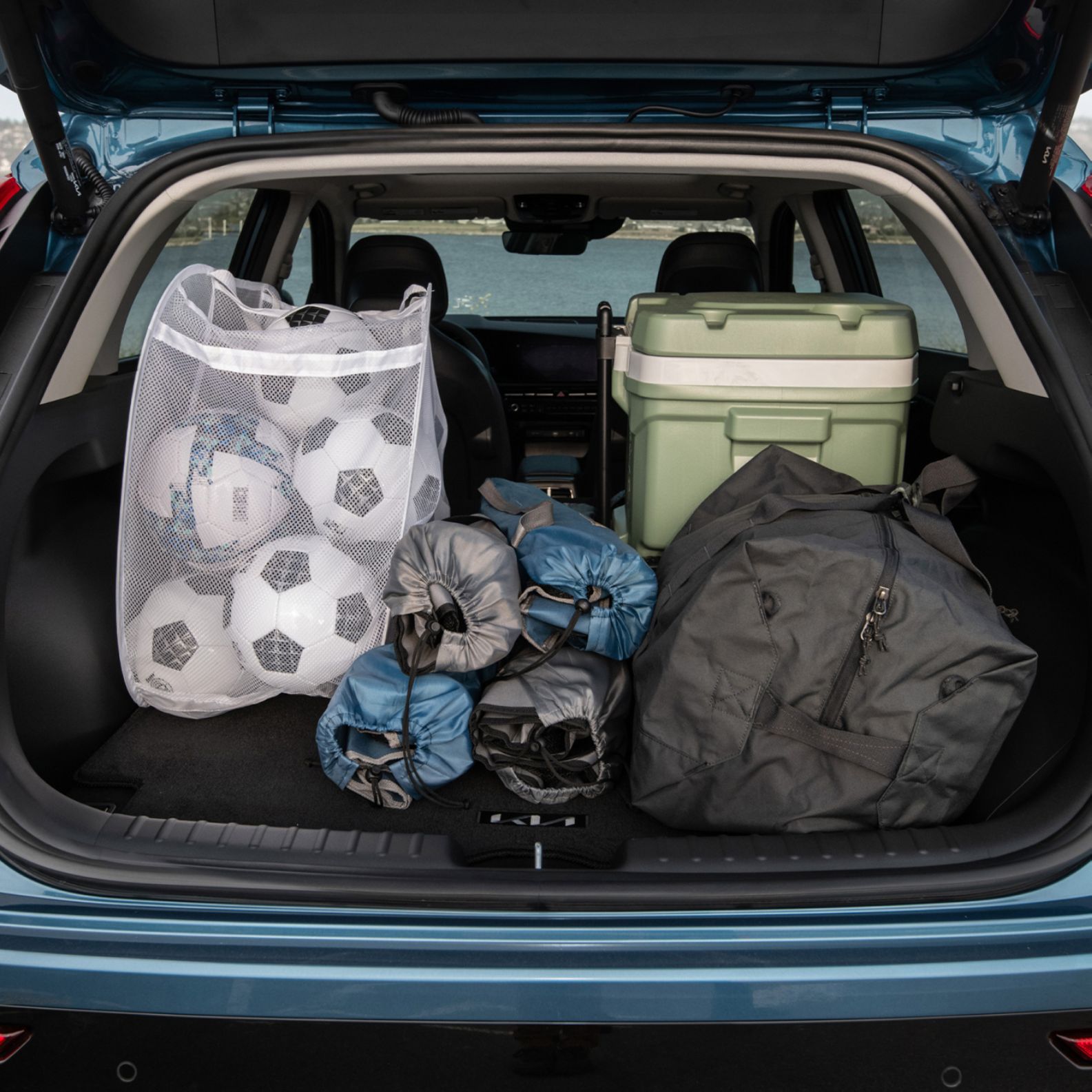 2025 Kia Niro Hybrid Best-In-Class Cargo Space Being Utilized To Pack Soccer Equipment Close-Up