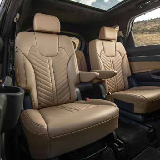 2024 Kia Sorento interior, three-quarter front view of the second row captain chair seats in brown leather